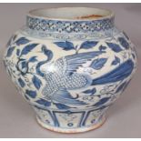 A CHINESE YUAN STYLE BLUE & WHITE PORCELAIN PHOENIX JAR, the base unglazed, 9.25in wide at widest