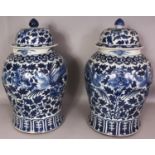 A VERY LARGE PAIR OF 19TH CENTURY CHINESE BLUE & WHITE PORCELAIN PHOENIX VASES & COVERS, the sides