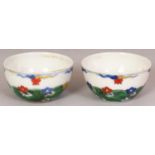 A PAIR OF CHINESE DOUCAI PORCELAIN CUPS, decorated with flowerheads strewn on waves, each base