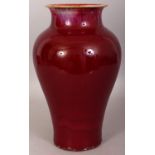 A 19TH CENTURY CHINESE FLAMBE GLAZED PORCELAIN VASE, the predominantly streaked red glaze turning to