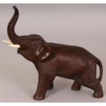 A SMALL JAPANESE MEIJI PERIOD BRONZE MODEL OF AN ELEPHANT BY SEIYA, with bone tusks, the underside