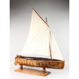 A LARGE EARLY WOODEN POND YACHT. 3ft 2ins long.