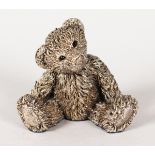 A SILVER MODEL OF A SEATED TEDDY BEAR. 3ins high.