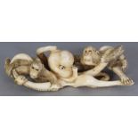A JAPANESE MEIJI PERIOD IVORY OKIMONO OF TWO MONKEYS FIGHTING WITH AN OCTOPUS, unsigned, the details