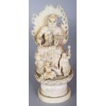 A SIGNED JAPANESE MEIJI PERIOD SECTIONAL IVORY OKIMONO OF A DEMON GOD, with attendants, seated on