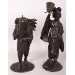 TWO EARLY 20TH CENTURY JAPANESE BRONZE FIGURES, one of a lady in geta holding up a lamp, the other