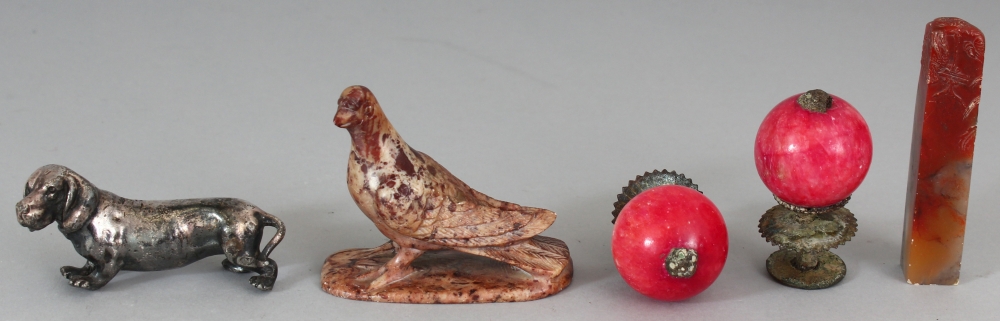 TWO CHINESE HAT BUTTONS, the tallest 2.3in high; together with a silvered metal model of a dog, 2.
