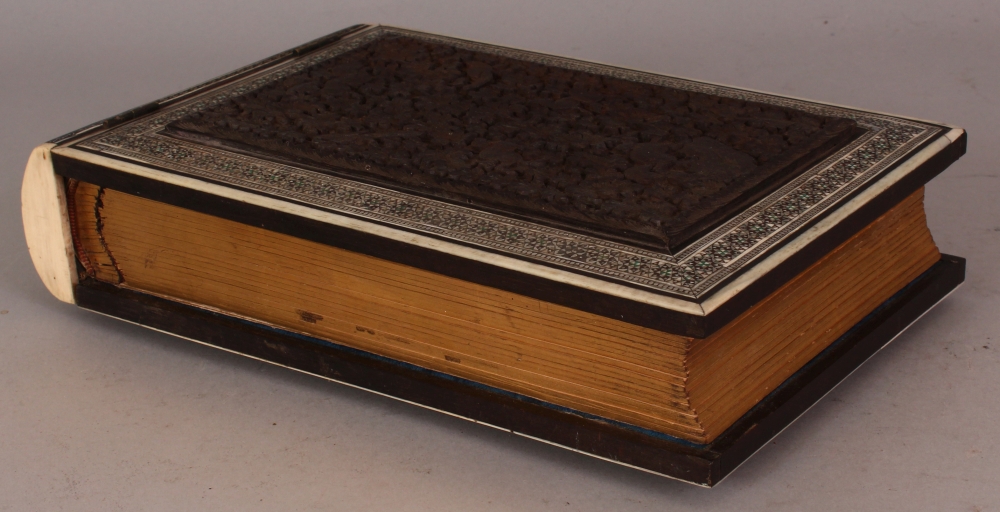AN EARLY 20TH CENTURY INDIAN PHOTO ALBUM, with carved sandalwood covers and mosaic inlaid and