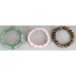 THREE HARDSTONE BRACELETS, composed of variously shaped beads, 2.5in diameter. (3)