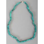 A TURQUOISE HARDSTONE NECKLACE, composed of small irregular beads, approx. 34.5in long.