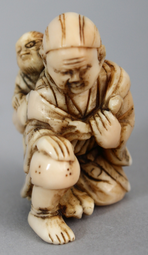 A JAPANESE MEIJI PERIOD IVORY NETSUKE OF EBISU, unsigned, the kneeling deity carrying a monkey