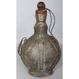 A LARGE ISLAMIC SILVERED METAL FLASK, with wood stopper, the sides with stud decoration and fitted