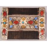 AN UNUSUAL EASTERN STONE INLAID & SILVER-METAL ONLAID WOOD COMB, 3.75in wide x 2.8in.