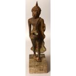 AN 18TH/19TH CENTURY SUKHOTAI STYLE BRONZE FIGURE OF THE WALKING BUDDHA SHAKYAMUNI, mounted on a