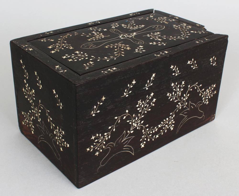 AN EASTERN BONE INLAID HEAVY HARDWOOD RECTANGULAR BOX, with sliding cover, decorated with meandering