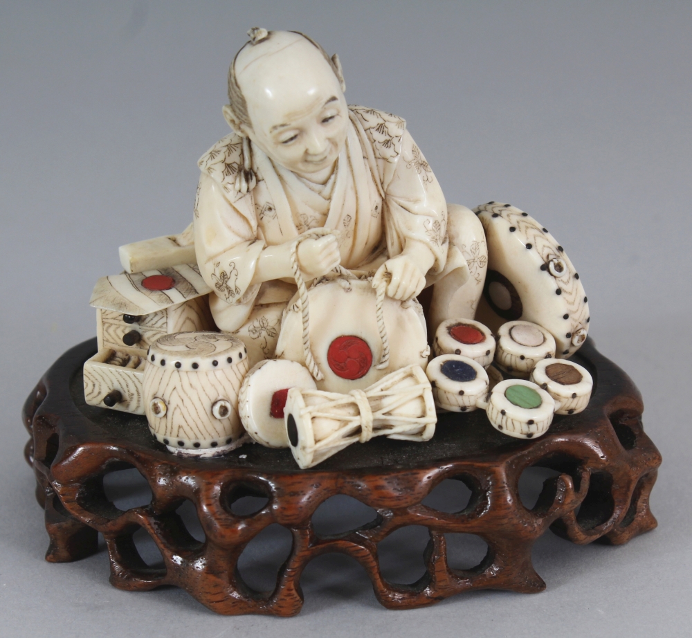 A GOOD SIGNED JAPANESE MEIJI PERIOD INLAID IVORY OKIMONO OF A DRUM SELLER, together with a fixed