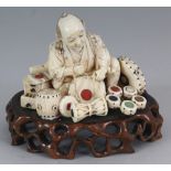 A GOOD SIGNED JAPANESE MEIJI PERIOD INLAID IVORY OKIMONO OF A DRUM SELLER, together with a fixed