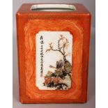 A CHINESE REPUBLIC STYLE SQUARE SECTION PORCELAIN BRUSHPOT, the panels reserved on an iron-red