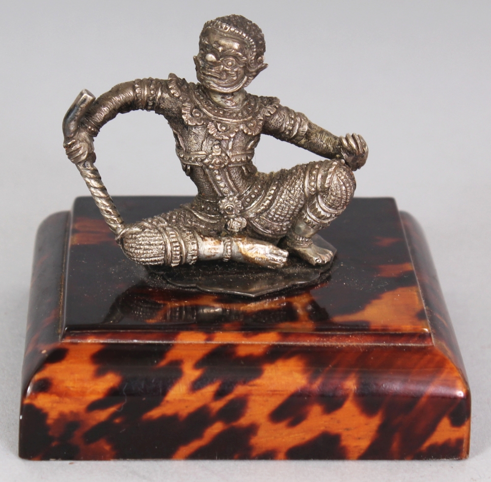 A SMALL GOOD QUALITY 19TH/20TH CENTURY THAI SILVER-METAL FIGURE OF A SEATED DEMON GUARDIAN,