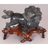 A 20TH CENTURY CHINESE HARDSTONE CARVING OF A STRIDING BUDDHISTIC LION, together with a fitted