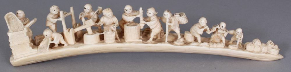 AN UNUSUAL SIGNED JAPANESE MEIJI PERIOD IVORY TUSK CARVING, in the form of a group of villagers at