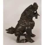 A SOUTH-EAST ASIAN BRONZE MODEL OF A LION TEMPLE GUARDIAN, 6.2in high.