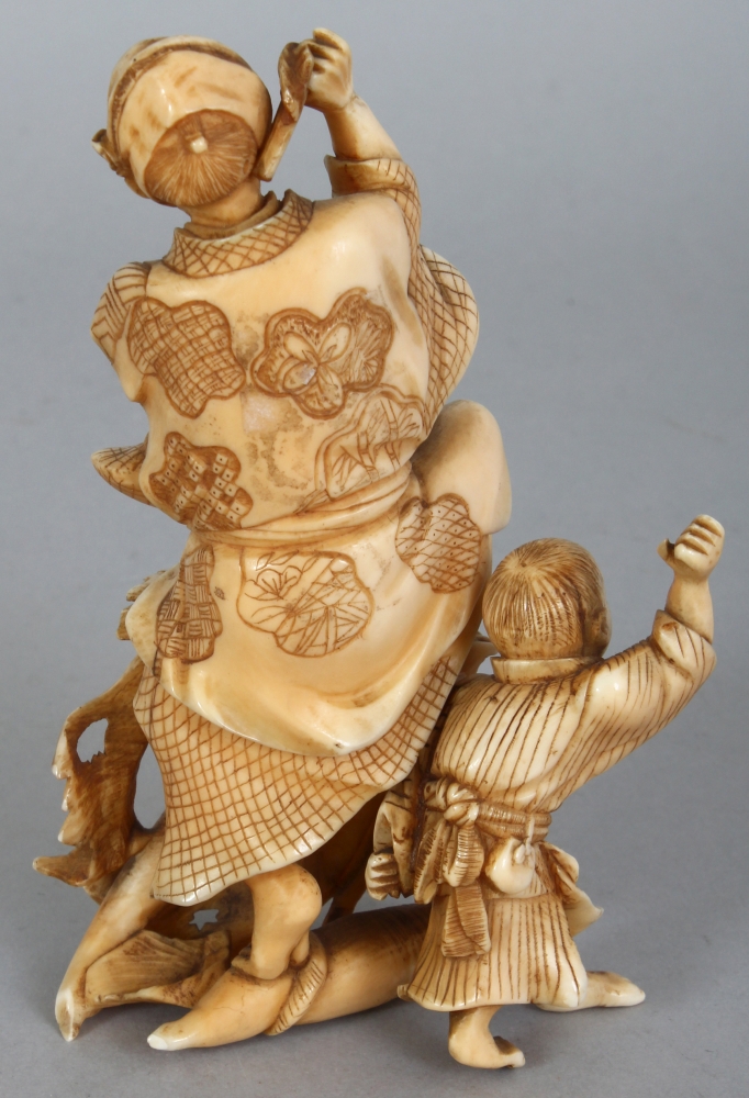 A JAPANESE MEIJI PERIOD IVORY OKIMONO OF A FARMER & HIS SON, unsigned, leaping before two giant - Image 3 of 8