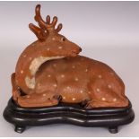 A GOOD JAPANESE MEIJI PERIOD BIZEN WARE POTTERY MODEL OF A DEER, together with a fitted wood
