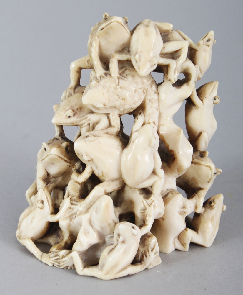 A GOOD SIGNED JAPANESE MEIJI PERIOD IVORY OKIMONO OF A LARGE GROUP OF TOADS, clambering over each