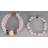 TWO ROSE QUARTZ HARDSTONE BANGLES, the largest approx. 2.75in diameter. (2)