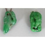 TWO SMALL CHINESE APPLE GREEN JADE PENDANTS, one with an attached chain, 1in & 1.2in high. (2)