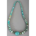 A TURQUOISE HARDSTONE NECKLACE, composed of graduated spherical beads, approx. 35.5in long.