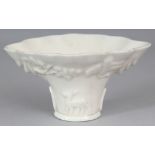 ANOTHER GOOD CHINESE KANGXI PERIOD DEHUA BLANC-DE-CHINE LIBATION CUP, of rhinoceros horn form, the