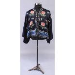 A GOOD 19TH CENTURY CHINESE DARK BLUE GROUND LADIES EMBROIDERED SHORT SILK JACKET, decorated in seed