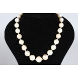 A FINE QUALITY GRADUATED PEARL NECKLACE with diamond clasp.