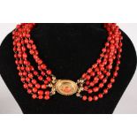 A GOOD SIX ROW CORAL BEAD NECKLACE with gold clasp, 69gms.