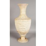 AN 18TH-19TH CENTURY ITALIAN CLASSICAL URN with female masks. 21ins high.