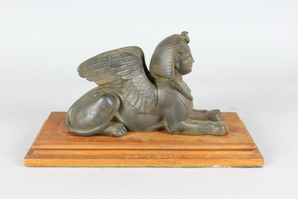 AN EGYPTIAN SPHINX on a mahogany base. 13ins long. - Image 3 of 4