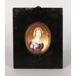 A VICTORIAN OVAL PORTRAIT MINIATURE OF A LADY in a blue dress with lace bonnet. 5.5cms x 4.5cms with