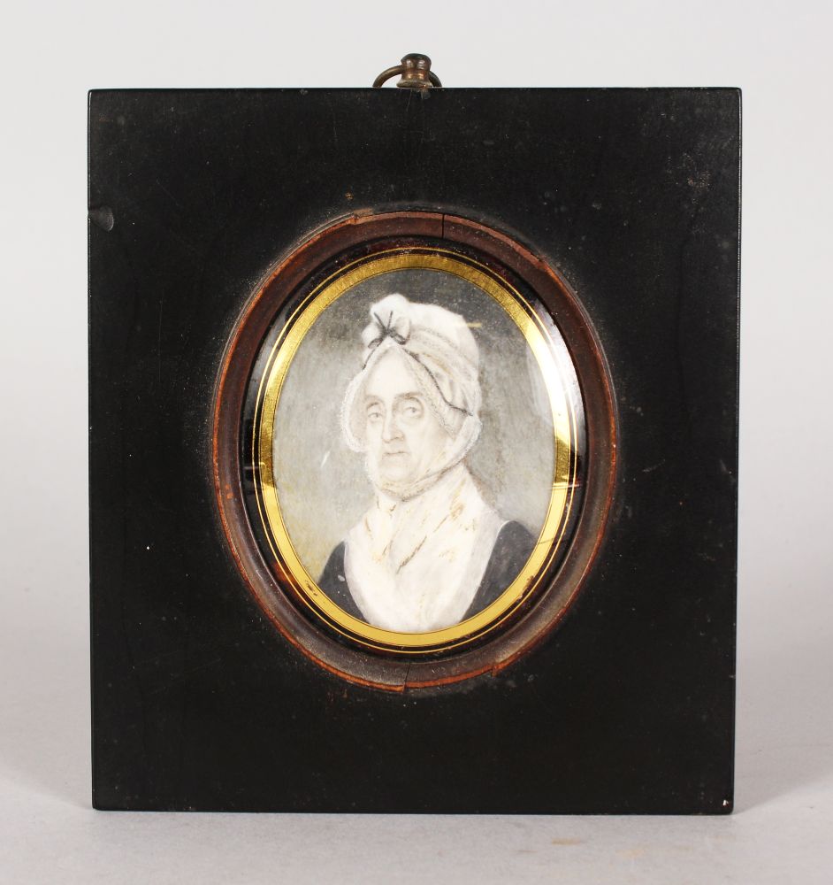 AN EARLY 19TH CENTURY OVAL PORTRAIT MINIATURE OF AN OLD LADY wearing a large bonnet. 8cms x 5.5cms