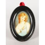 A 19TH CENTURY OVAL PORTRAIT MINIATURE OF A YOUNG GIRL with long flowing hair. 8cms x 5cms in a