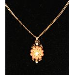 A CORAL AND PEARL PENDANT on a 9ct gold chain.