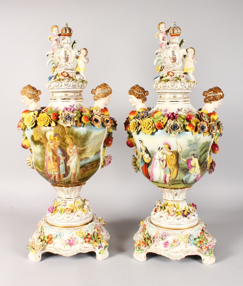 A GOOD LARGE PAIR OF DRESDEN STYLE FLOWER ENCRUSTED URNS, COVERS AND STANDS, painted with