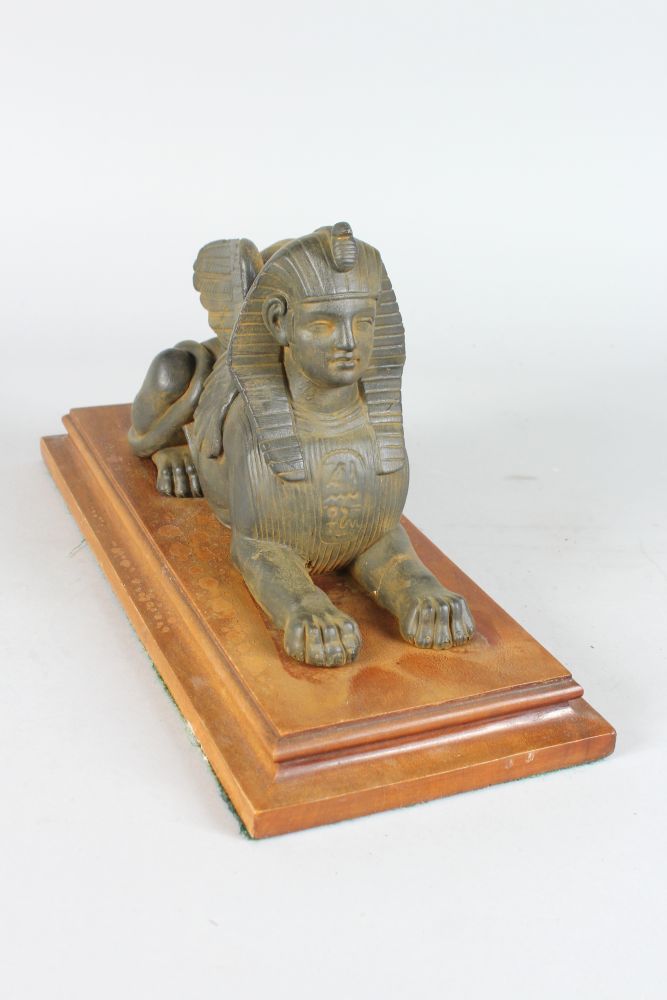 AN EGYPTIAN SPHINX on a mahogany base. 13ins long. - Image 2 of 4