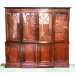 A GOOD GEORGIAN MAHOGANY BREAKFRONT BOOKCASE, the top with dentil cornice, four glazed astragal