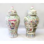 A VERY LARGE FLOOR STANDING PAIR OF FAMILLE ROSE VASES AND COVERS, richly decorated throughout