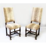 A PAIR OF 18TH CENTURY OAK HIGH BACK CHAIRS, upholstered in faux leopard skin (2).