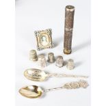 A FILIGREE BODKIN HOLDER, FIVE THIMBLES, TWO SPOONS and A MINIATURE PHOTO FRAME (9).