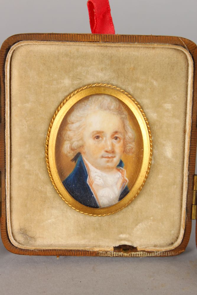 A SMALL 18TH CENTURY OVAL PORTRAIT MINIATURE OF A GENTLEMAN, wearing a blue coat and white cravat. - Image 2 of 3
