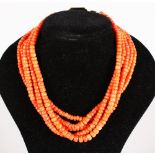 A GOOD FIVE ROW CORAL BEAD NECKLACE with gold clasp, 97gms.